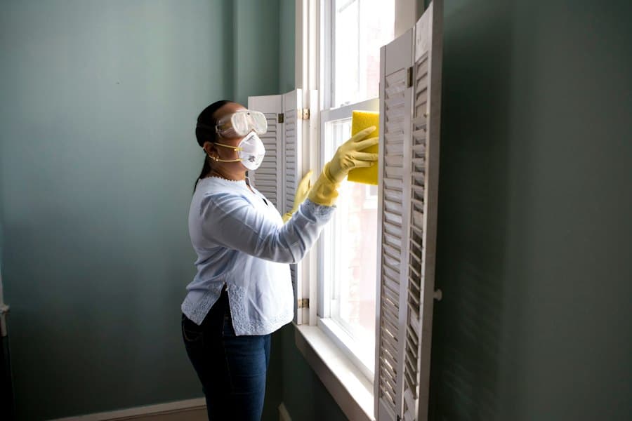 House cleaner wiping a window