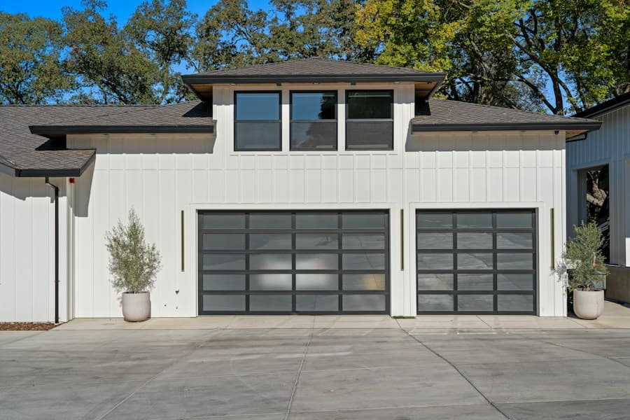 Modern home with two glass garage doors