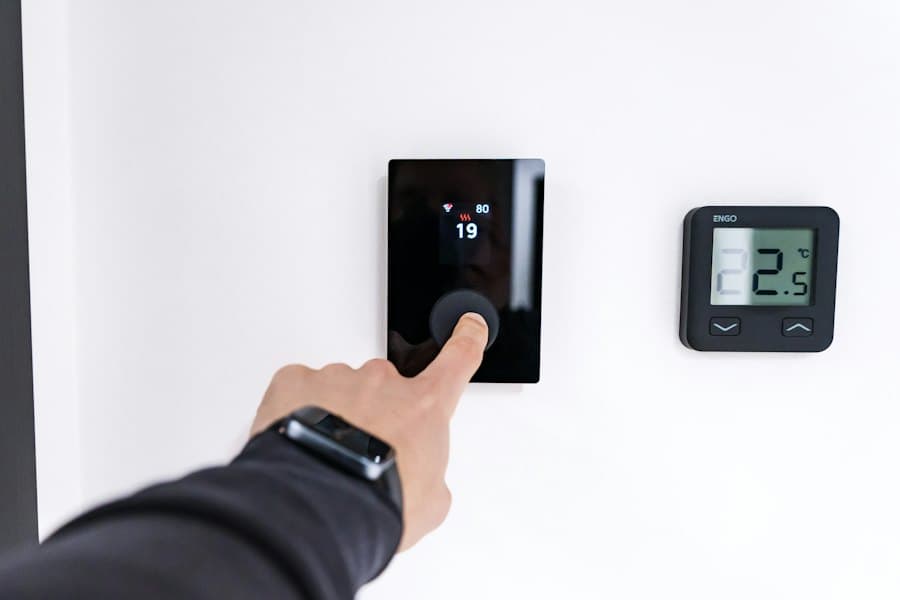 Hand adjusting a smart thermostat