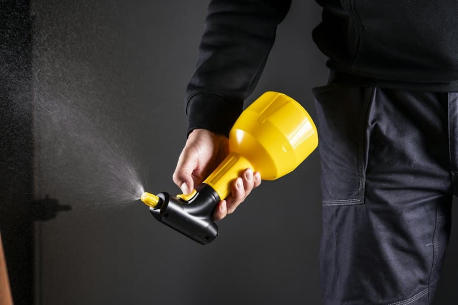 Technician spraying pest treatment